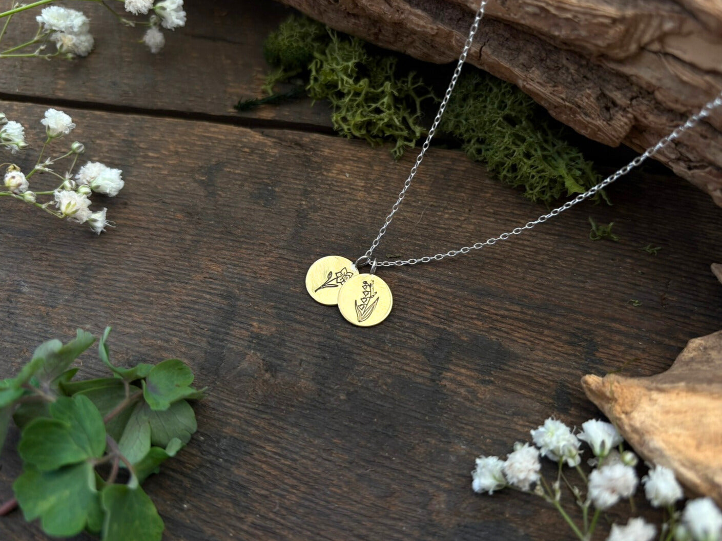 Brass birth flower bouquet necklace by curious magpie jewellery featuring charms on a necklace with engraved birth flowers on each charm.