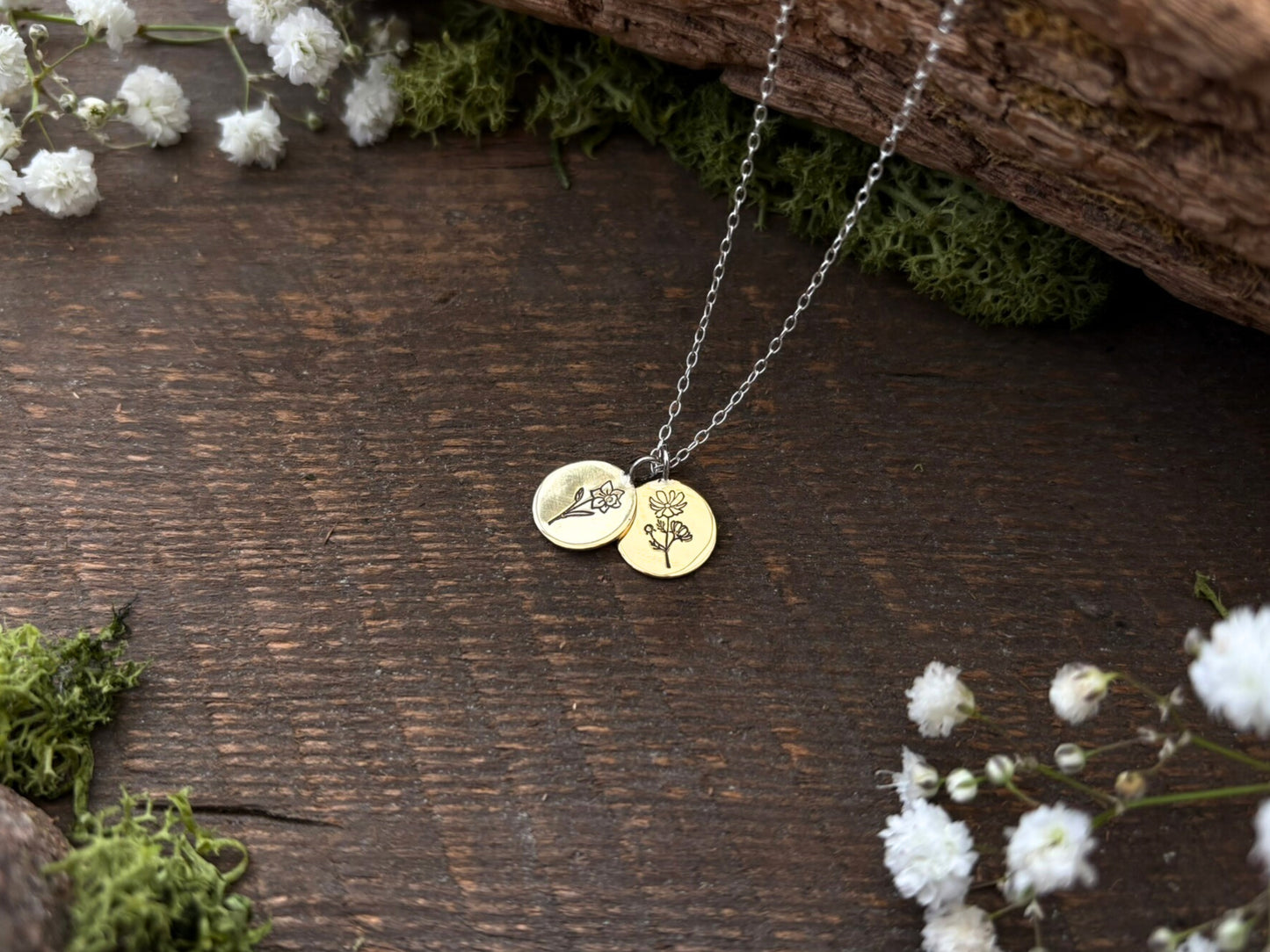 Brass birth flower bouquet necklace by curious magpie jewellery featuring charms on a necklace with engraved birth flowers on each charm.